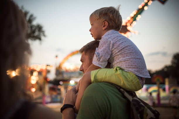 istock Young family with son on street fair. 1027687180