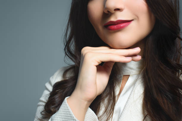 istock partial view of woman with red lips, isolated on grey 1027693256