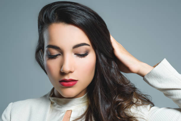 istock beautiful brunette girl with red lips, isolated on grey 1027693274