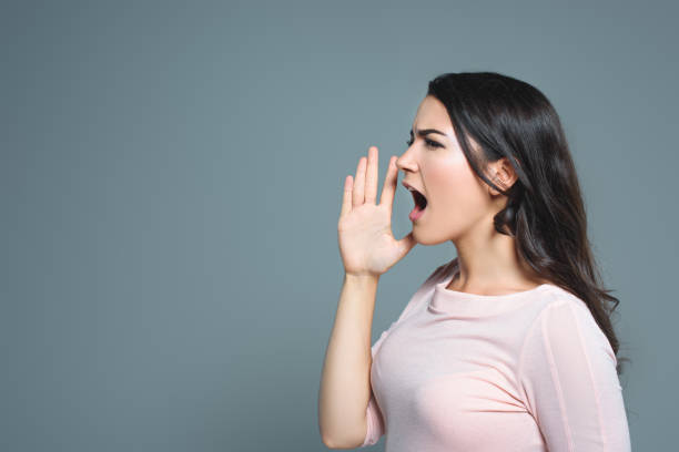 istock attractive emotional girl gesturing and yelling, isolated on grey 1027693406