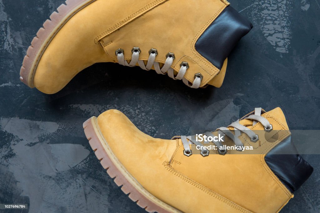 Women's winter boots. Yellow warm boots for trekking Women's winter boots. Yellow warm boots for trekking. Adventure Stock Photo