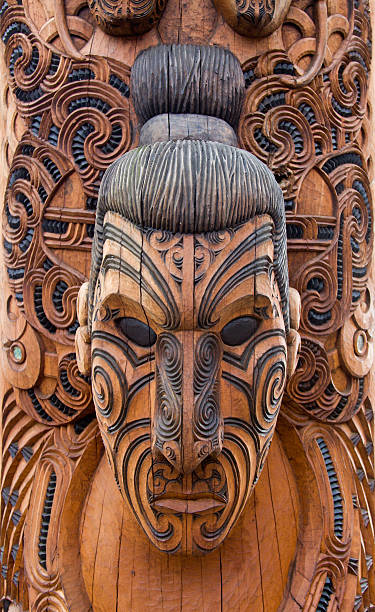 Close-up of a brown and black Maori carving of a man stock photo