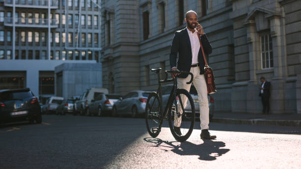 istock Businessman going to office by bicycle and talking on phone 1027697442