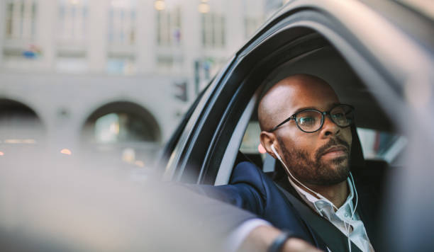 Relaxed businessman traveling by a car