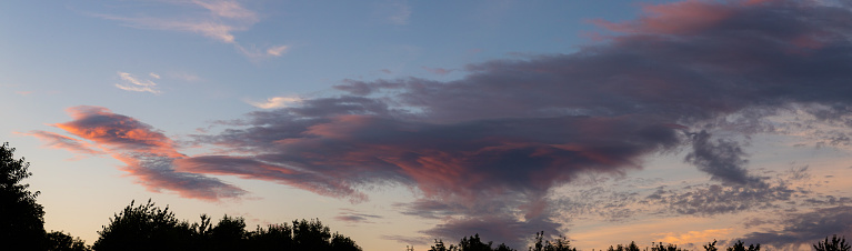 A large cloud tinged red at sunset.