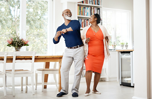 Shot of a happy mature couple dancing together at home