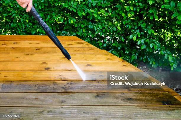 Cleaning Terrace With A Power Washer High Water Pressure Cleaner On Wooden Terrace Surface Stock Photo - Download Image Now