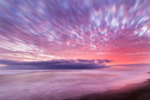 istock Las Machas Beach. Clouds with the last sunrays impacting over it creating an amazing palette on an infinite horizon, enjoying twilight lights over a colorful sky at Arica, Chile 1027723538