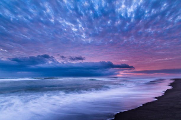 istock Las Machas Beach. Clouds with the last sunrays impacting over it creating an amazing palette on an infinite horizon, enjoying twilight lights over a colorful sky at Arica, Chile 1027723546