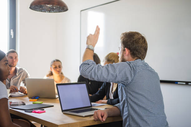 istock Businessman asking a question with raised hand 1027724080