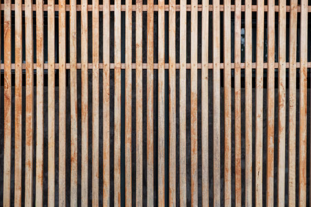 istock Modern wooden brown lath decoration on facade 1027731742