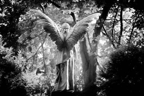 istock Antique Angel Statue on a Graveyard 1027734956