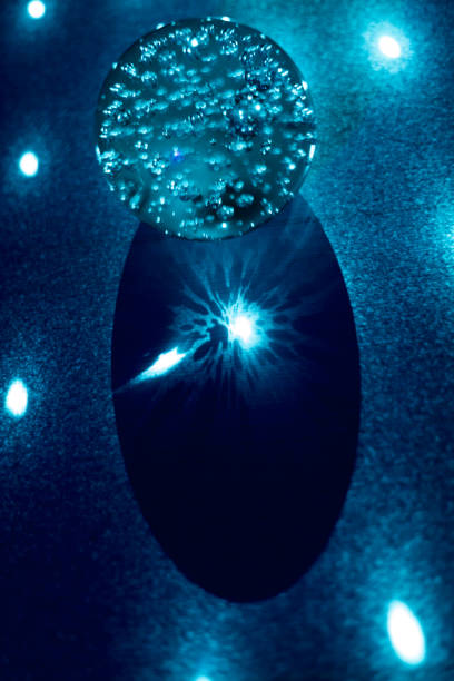 istock On the glass sphere, the laser beams are reflected from it 1027735344