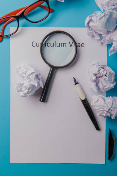 Curriculum vitae written on an blank white paper Curriculum vitae written on an blank white paper on blue background good cv stock pictures, royalty-free photos & images
