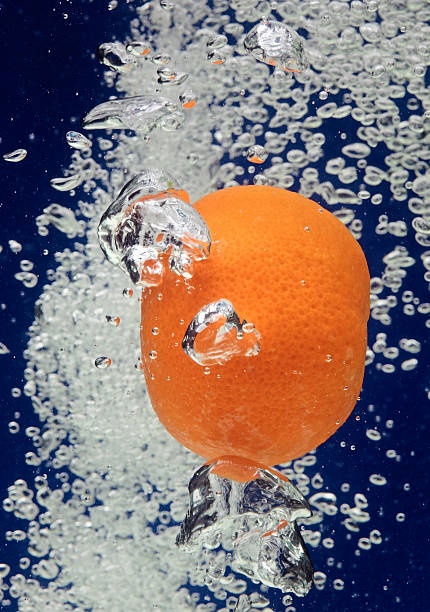 istock Orange (mandarin) falling in water with air bubbles 102773627