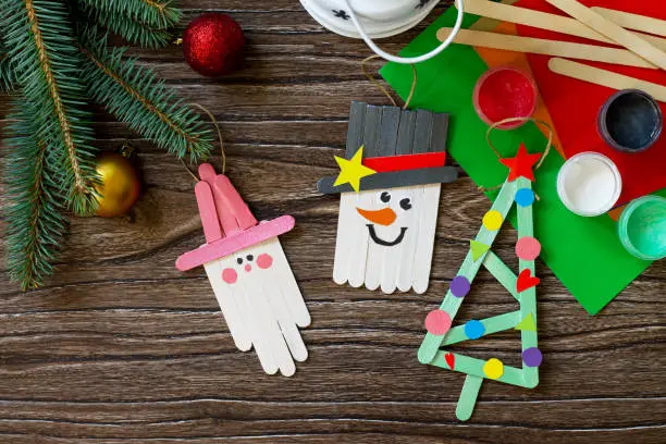 Christmas decoration or Christmas gift wooden sticks - Snowman, fir-tree and Santa. Handmade. Project of children's creativity, handicrafts, crafts for kids.