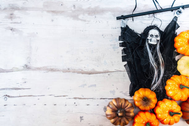 istock Halloween concept with a pumpkin and skeleton on background 1027739222