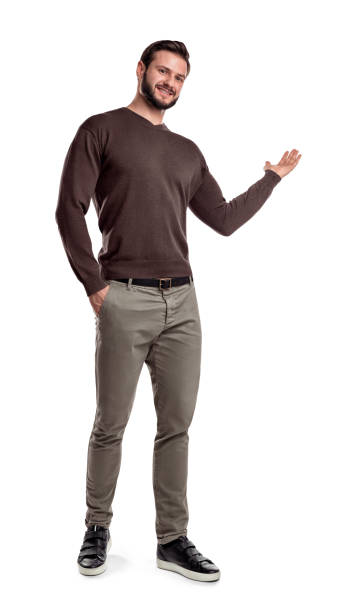 A man casual wear makes a short step, smiles and shows something with one of his arms on a white background A man casual wear makes a short step, smiles and shows something with one of his arms on a white background. Presentation. Showing new product. Promoting. this side is for address only stock pictures, royalty-free photos & images