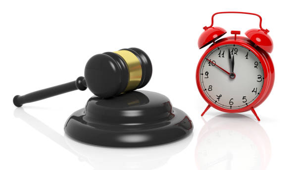 istock 3D rendering of gavel and red alarm clock, isolated on white background. 1027746224