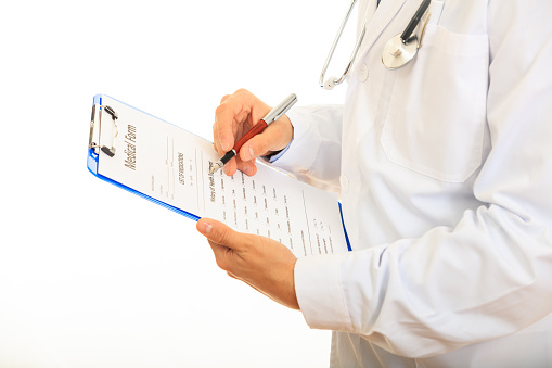 Doctor holding a blue clipboard on white background