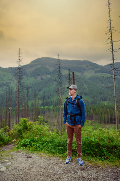 istock Man tourist in mountain trail 1027752598