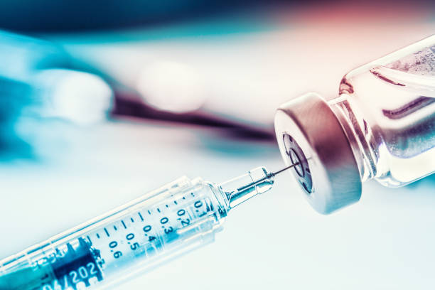 istock Close-up medical syringe with a vaccine. 1027752634