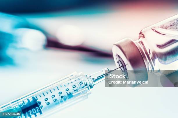 Closeup Medical Syringe With A Vaccine Stock Photo - Download Image Now - Vaccination, Syringe, Injecting