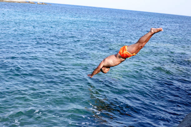 istock Jump in the blue sea 1027758230