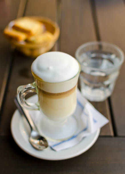 Latte coffee on wood table with coffee beans top of view