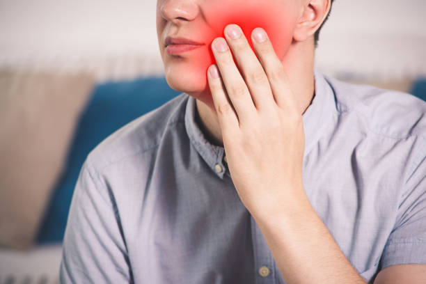 istock Man suffering from a toothache at home 1027768518