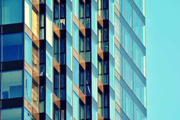istock Modern office building on a clear sky background. Retro stylized colorful tonal filter effect 1027771062