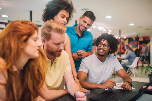 istock Young business team having a discussion at a desk with a laptop 1027771072