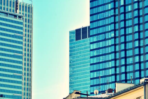 istock Modern office building on a clear sky background. Retro stylized colorful tonal filter effect 1027771388