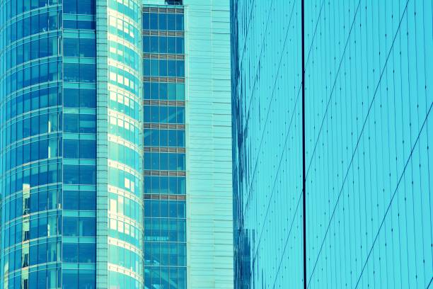 istock Modern office building on a clear sky background. Retro stylized colorful tonal filter effect 1027772616