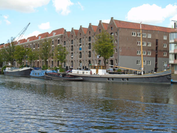 istock Buildings, rivers, and barges in Amsterdam, Holland 1027777710