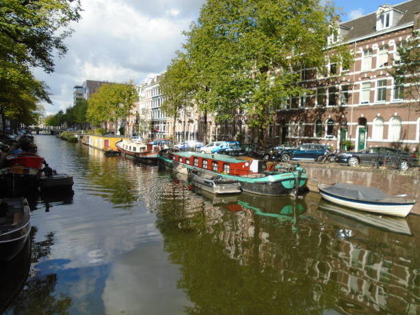 istock Buildings, rivers, and barges in Amsterdam, Holland 1027777736
