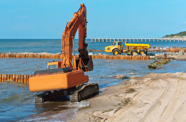 istock coastal protection measures, construction equipment on the shore, the construction of breakwaters 1027781628