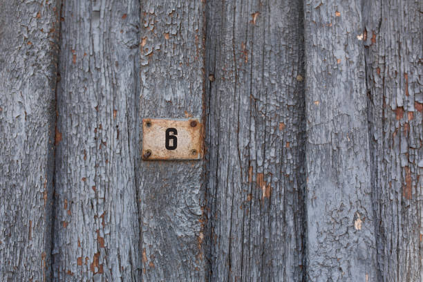 istock old wooden door with peeling and cracked grey paint 1027789704