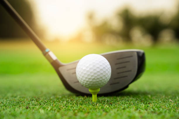 istock Golf course green and golf ball close in the grass field 1027790144