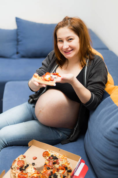 istock Pregnant woman eating 1027792434
