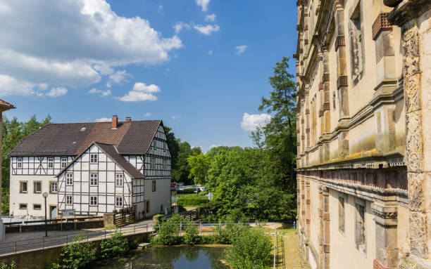 Lemgo, Germany - May 9, 2018: Pond and half timbered house at the Brake castle in Lemgo, Germany