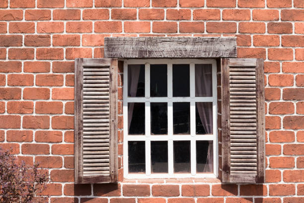 istock anceint wooden window and brick wall 1027800370
