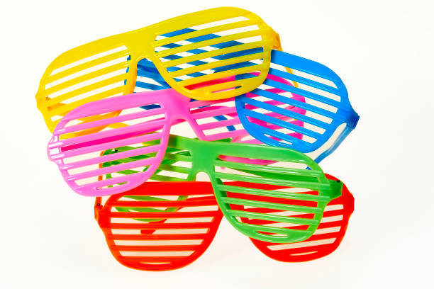 Stack of colorful slot glasses on white background