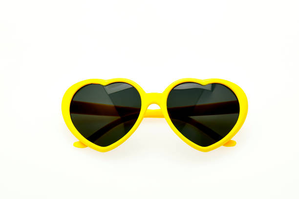 istock Heart shaped sunglasses on white background - yellow frame 1027804744