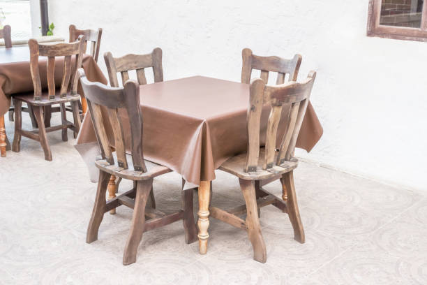 istock Country-style wooden dining table with leather tablecloth 1027806792