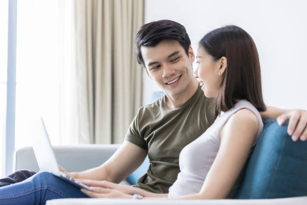 istock Cheerful couple relaxing in their home 1027807430