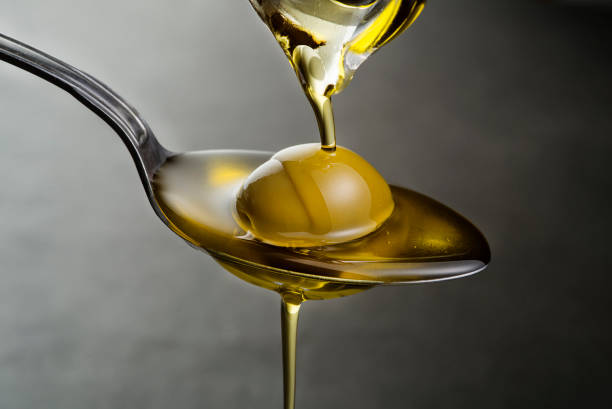 istock Bottle of virgin olive oil pouring 1027810708