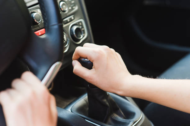 Picture of female hands and gear lever Woman in vehicle interior on driver seat handbook photos stock pictures, royalty-free photos & images