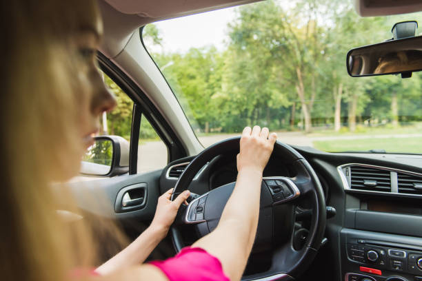 istock Happy blondy female driving at vehicle interior 1027820056