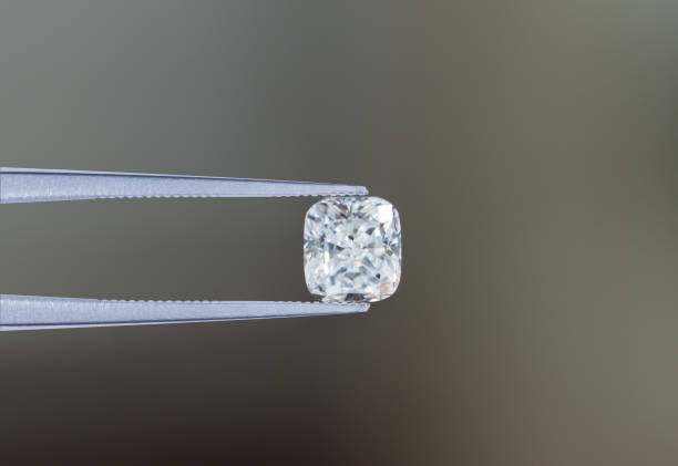 istock Macro diamond white stone in tweezers 1027823502